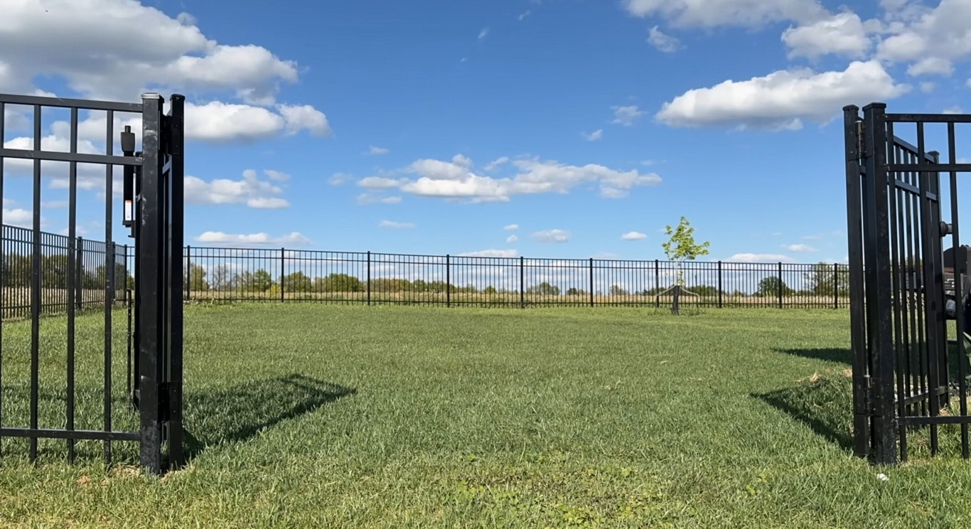 Black ornamental aluminum fence with secure gate installation